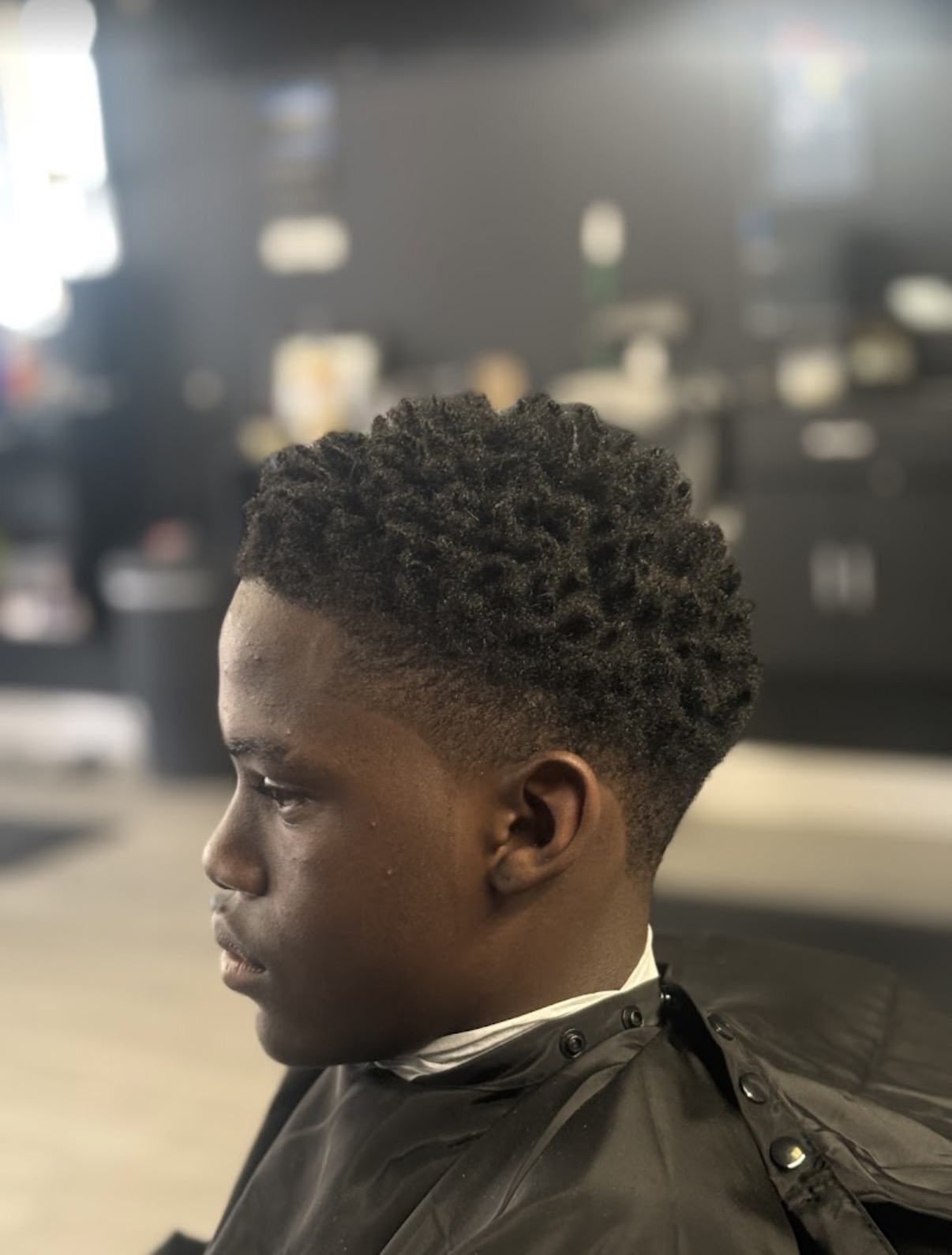Curly high taper fade on natural hair at Verified Cuts 2 barbershop in Fort Mill, SC.