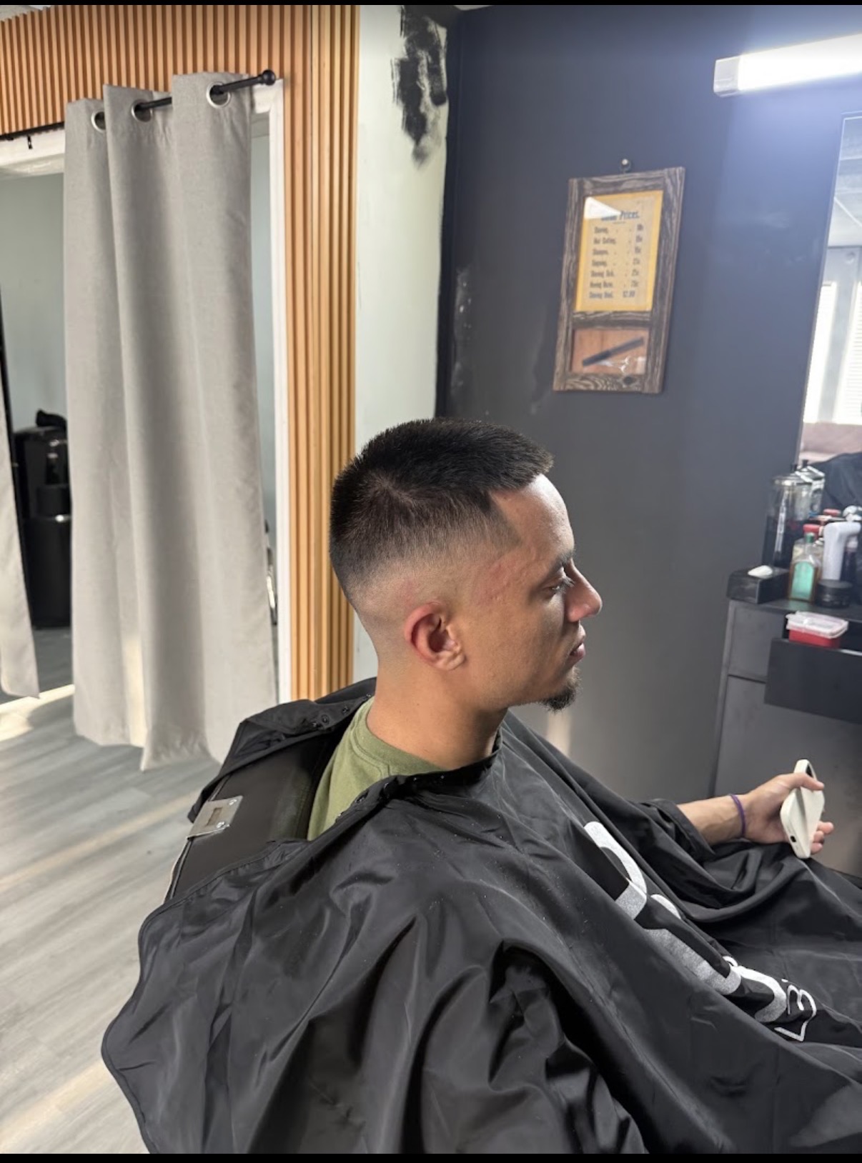 Customer with curly textured hair and a taper fade after his appointment in Fort Mill, SC.