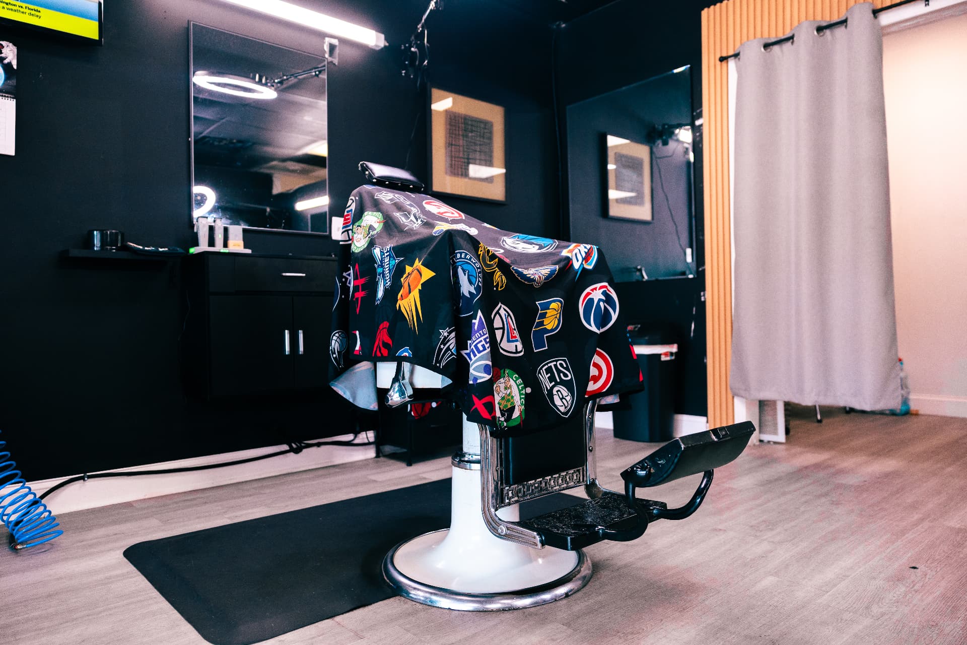 Classic barber chair with an NBA cape at Verified Cuts 2 barbershop in Fort Mill, SC.