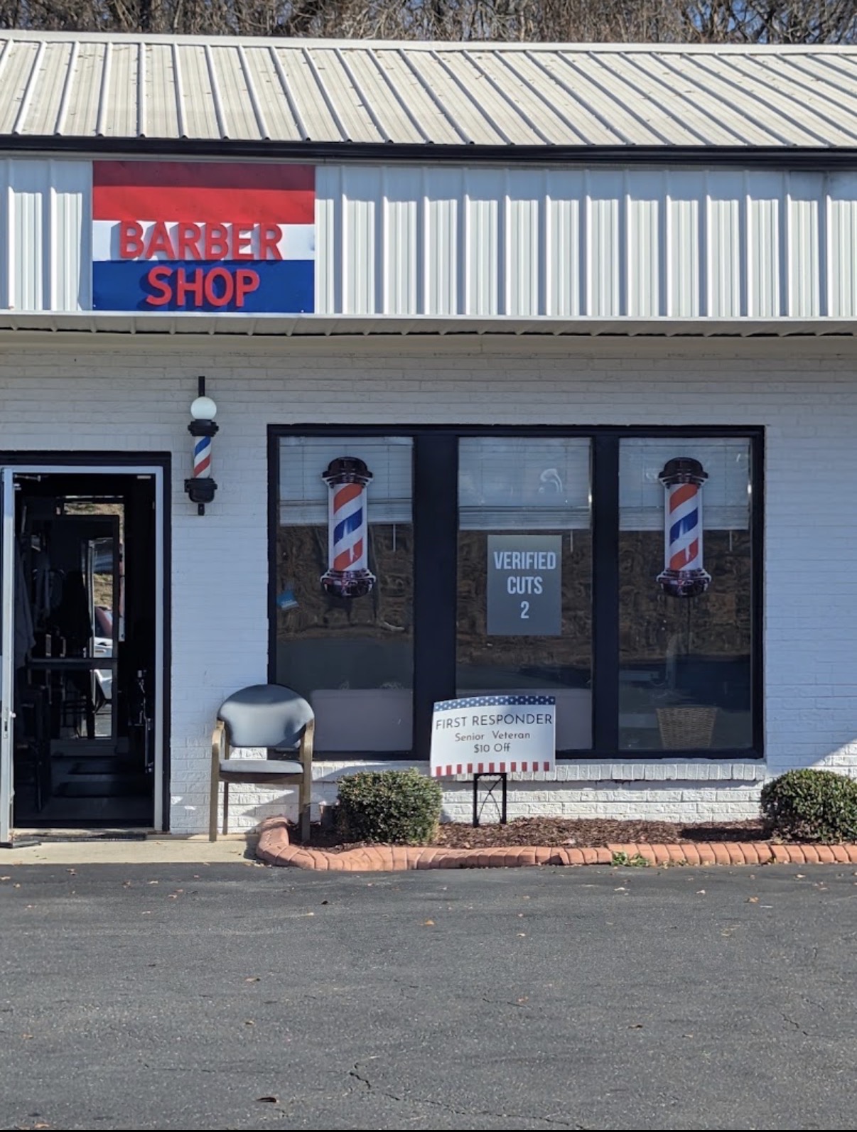 Verified Cuts 2 barbershop storefront in Fort Mill, South Carolina with barber poles at the entrance.